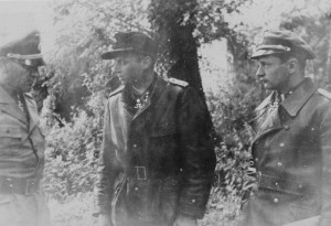 After the Battle. Wittmann discusses the day's events with regimental commander SS-Obergruppenführer und General der Waffen-SS Josef 'Sepp' Dietrich and 1st SS Panzer Corps adjutant, SS-Hauptsturmführer Hermann Weiser