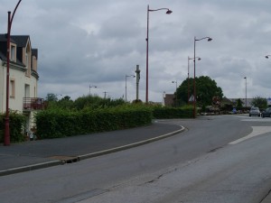 The view back down from Rue Georges Clemenceau to the Tilly Junction, with the Calvary in the foreground