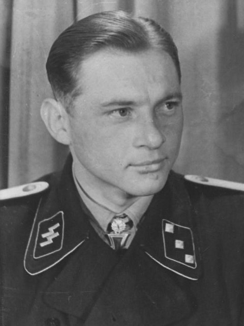 The newly-promoted Wittmann wears his Oakleaves, but is yet to upgrade his rank collar patch to SS-Obersturmführer