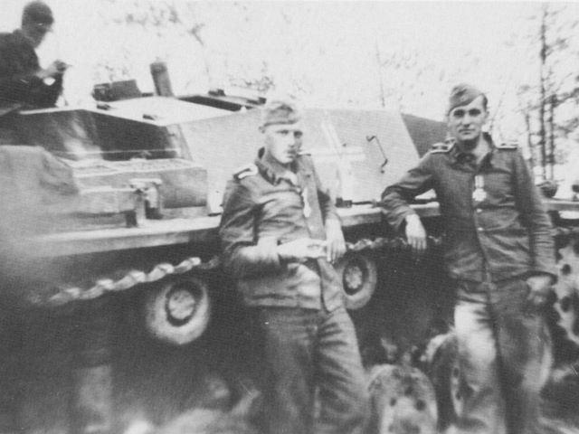 Wittmann (front, left) and his driver Philipp Fritz stand in front of their StuG III nicknamed “Buzzard”, following their being awarded the Iron Cross Second Class on 12th July 1941