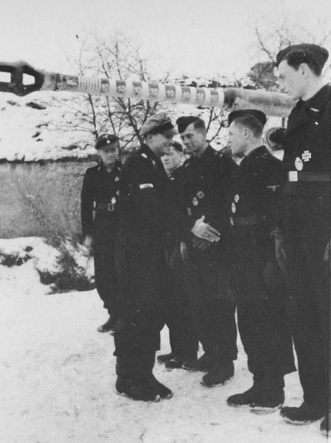 Knight’s Cross winner Michael Wittmann and his crew are congratulated by Joachim “Jochen” Peiper. The “kill marks” are clearly visible on the Tiger’s gun.